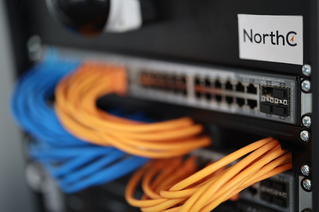 Network cabling installer terminating Cat6 patch panels in a commercial server rack